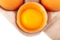 Egg Chicken eggs. Top view of an open gray box with brown eggs Isolated on a white background. One egg is half broken Royalty Free Stock Photo