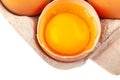 Egg Chicken eggs. Top view of an open gray box with brown eggs Isolated on a white background. One egg is half broken Royalty Free Stock Photo