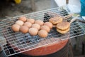 Egg chicken grilled on stove on street food, tasty snack north-east Thai cold weather