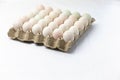 egg container with full of chicken eggs on white background