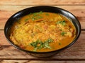 Egg Curry omelet is special indian spicy food, served in a ceramic bowl over rustic wooden background. Selective focus