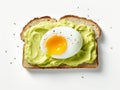 Egg cut in half on a rectangular slice of bread spread with avocado cream