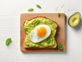 Egg cut in half on a rectangular slice of bread spread with avocado cream