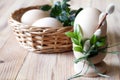 Egg in egg cup decorated catkins and boxwood and eggs in basket on wooden background, easter concept Royalty Free Stock Photo