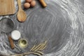 Egg, flour, olive oil, milk, wheat ears, kitchen tool on gray table background Royalty Free Stock Photo
