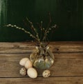 glass vase branch buds eggs wood table close-up easter spring