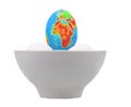 Egg in the form of globe in white cup.