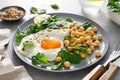 Egg fried, boiled chickpea and fresh spinach for healthy breakfast