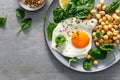 Egg fried, boiled chickpea and fresh spinach for healthy breakfast, top view