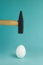 Egg and hammer hovering over it, before the hit Royalty Free Stock Photo