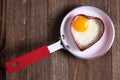 Egg in heart shape on fry pan Royalty Free Stock Photo