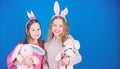 Egg hunt. Family and sisterhood. Spring holiday party. Little girls with hare toy. Happy easter. Children in rabbit Royalty Free Stock Photo