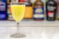 Egg liqueur in shot glass prepared by the bartender on the background of bottles in the bar Royalty Free Stock Photo