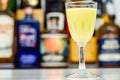 Egg liqueur in shot glass prepared by the bartender on the background of bottles in the bar Royalty Free Stock Photo