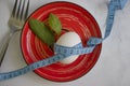 Egg, measuring tape, lettuce leaf in a plate fitness