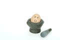 Egg on mini kitchen mortar, making funny face, isolated on white background