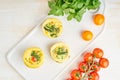 Egg muffins, paleo, keto diet. Omelet with spinach, vegetables, tomatoes baked in small molds, top view Royalty Free Stock Photo