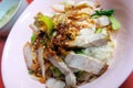 Egg noodle hot and sour soup with red roasted pork and crispy belly pork, Thailand street food. Royalty Free Stock Photo