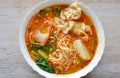 Egg noodle with pork dumpling in spicy soup on bowl
