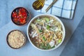 Egg noodle soup with many fresh vegetable and many topping, Thai noodle style