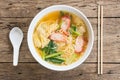 Egg noodle soup with red roasted pork in white bowl on wood background, Flat lay composition, Top view Royalty Free Stock Photo