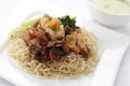 Egg noodle topped with stir fried ham and seafood Royalty Free Stock Photo