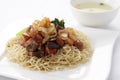 Egg noodle topped with stir fried ham and seafood