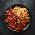 Egg noodles with bean sprouts and Crispy shredded beef on black plate Royalty Free Stock Photo