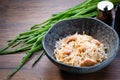 Egg noodles with chicken in a bowl on wooden table background. Cooked Thai egg noodles with green onion and seasoning Royalty Free Stock Photo