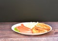 Egg omelette, boiled sausages and bread croutons with lettuce on a wooden table Royalty Free Stock Photo