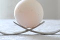 Egg over two forks as a monument close-up, macro Royalty Free Stock Photo