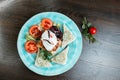 Egg `Poached` with slices of fresh tomatoes and fried toasts with delicious pate and greens on a blue plate in a restaurant of G Royalty Free Stock Photo