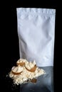 Egg protein powder heap and egg shells, white package mock up with copy space, isolated on black background Royalty Free Stock Photo