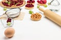 Egg and rolling pin. Flour in sieve. Tartlets with berries Royalty Free Stock Photo