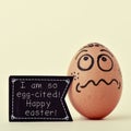 Egg with a signboard with the text I am so egg-cited, happy east Royalty Free Stock Photo