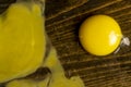 egg smashed on a black table, a broken cracked chicken egg spreads on a black wooden board, top view Royalty Free Stock Photo