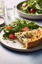 Egg and spinach quiche with cherry tomatoes on a plate in the kitchen. A healthy breakfast menu. Royalty Free Stock Photo
