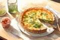 Egg and spinach quiche with cherry tomatoes on a plate in the kitchen. A healthy breakfast menu. Royalty Free Stock Photo