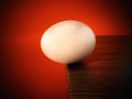 Egg standing at the edge of the table. 3D illustration Royalty Free Stock Photo