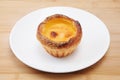 Egg tart cheese pie on a plate on cutting board