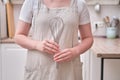 Egg whisk in the hands of a woman in the kitchen. Women`s hands hold a whisk for an omelet Royalty Free Stock Photo