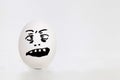 Egg on white background with face pattern. Royalty Free Stock Photo