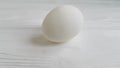 An egg on a white wooden spun slow motion