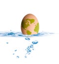 Egg with world map drop in blue water Royalty Free Stock Photo