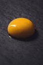 Egg yolk on black textured background Royalty Free Stock Photo