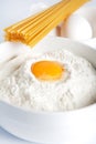 Egg yolk in a bowl of flour