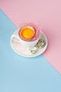 Egg yolk of broken eggs in the shell in a white coffee cup on a Royalty Free Stock Photo