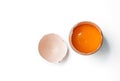 Egg yolk in egg shell, cracked egg white