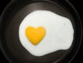 Egg yolk heart-shape Royalty Free Stock Photo