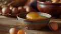 Egg yolks in a clay bowl on a wooden table Royalty Free Stock Photo